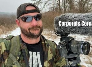 Corporals Corner with his vlogging camera in snowfall