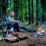 DonVonGun with his dog Musen resting near a outdoor camp