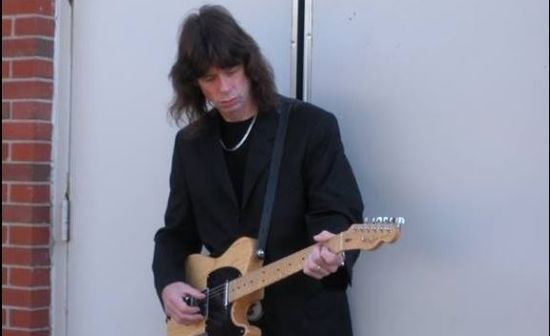 Photo of Scott Wahlberg holding his guitar