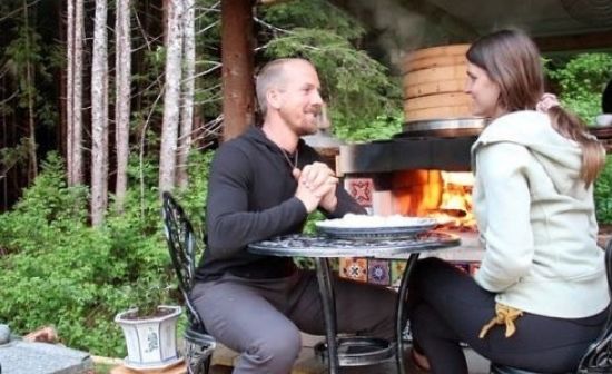 Jake and Nicole Mace enjoying their pizza near hot fire