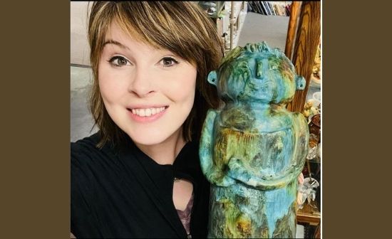 crazy lamp lady holding turquoise italian pottery at the Mad Hatter Antiques